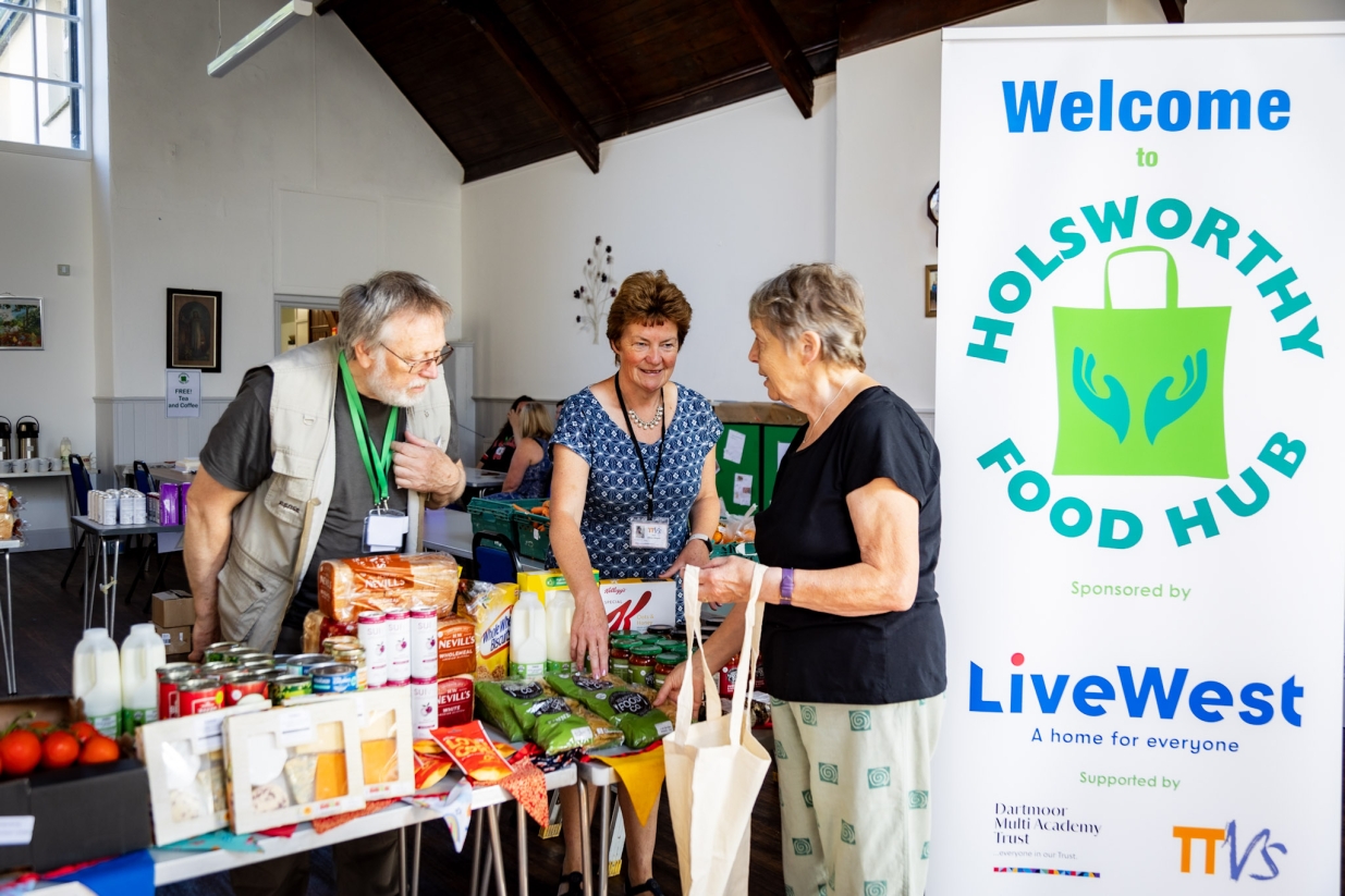 Shoppers talking to volunteers at the opening of the food hub.