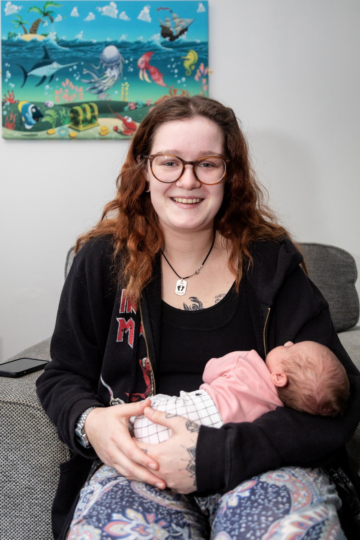 Ava smiling whilst cuddling her daughter, Winnie.