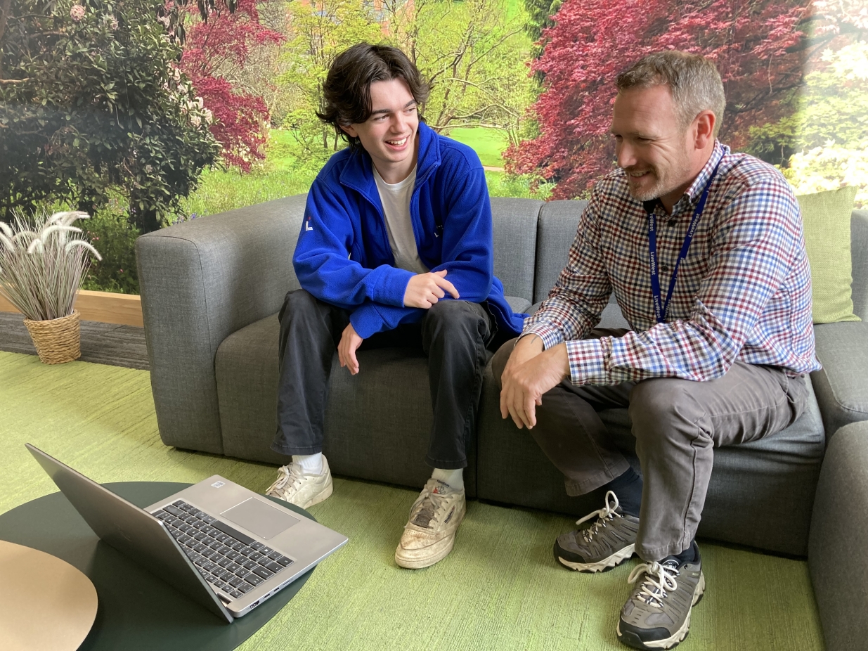 T-Level student Sam andcolleague Shane sat on a sofa in the office.