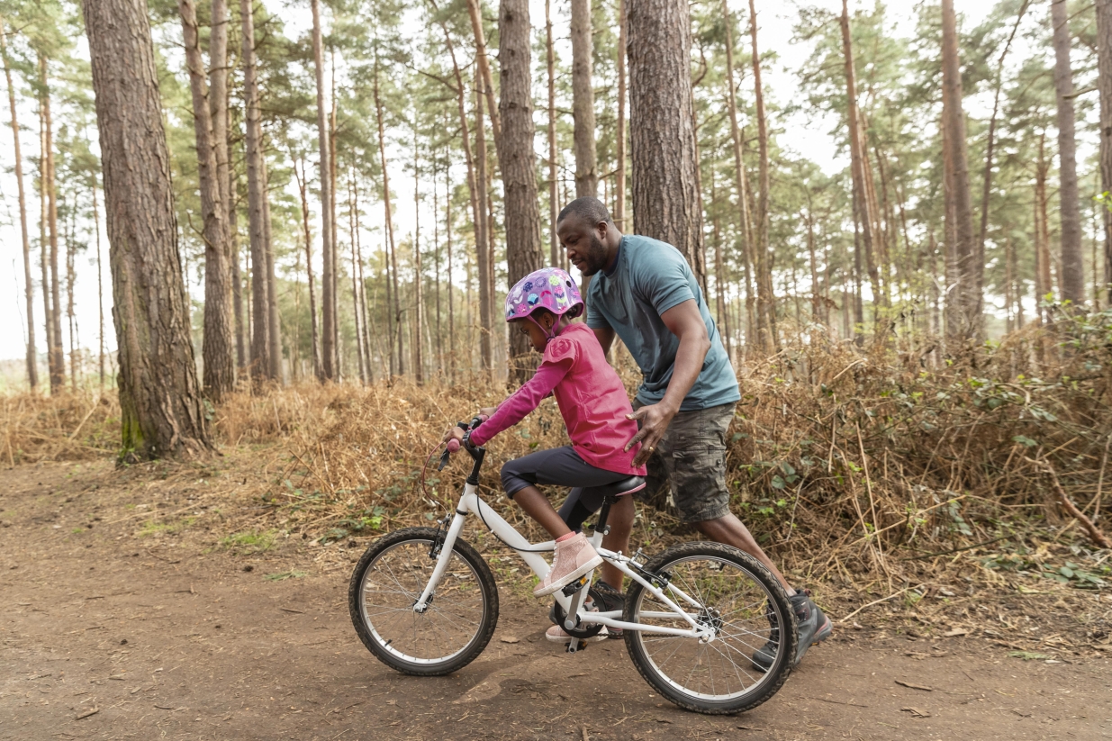 father and daughter on a bike ride