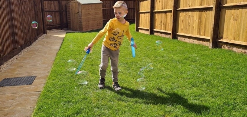 Jaxson playing in his new garden in Hartcliffe
