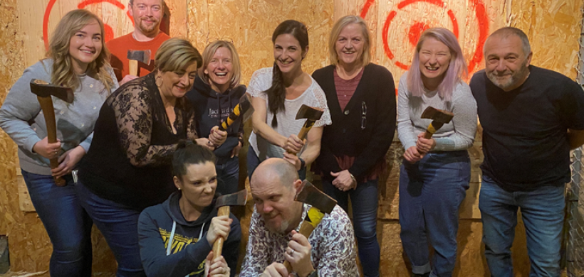 Paul and his friends at an axe throwing class