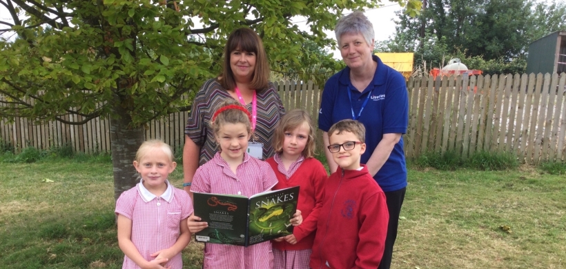 Our colleague Ali Knight presenting the book vouchers to the Headteacher and pupils at Lamerton Primary School.