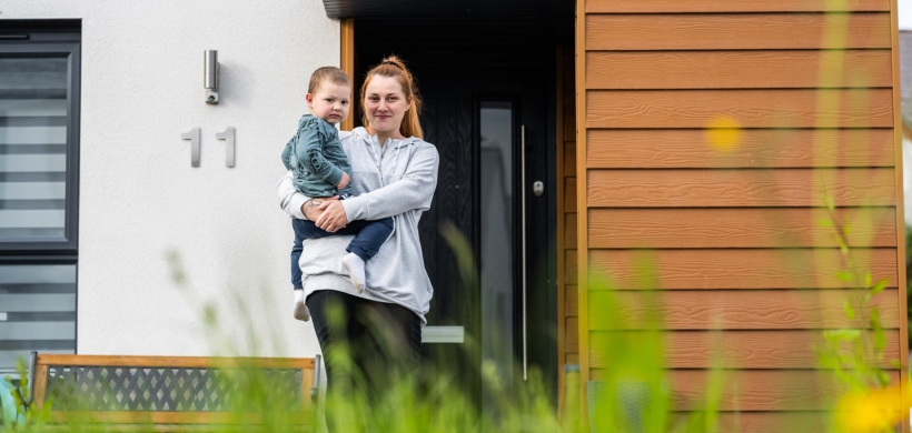 Aga and her son in front of her home in Sparkford