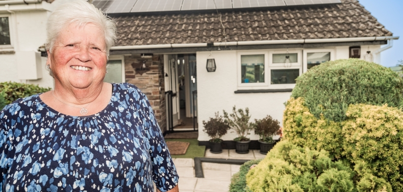 Carol Harris outside her home with new solar panels