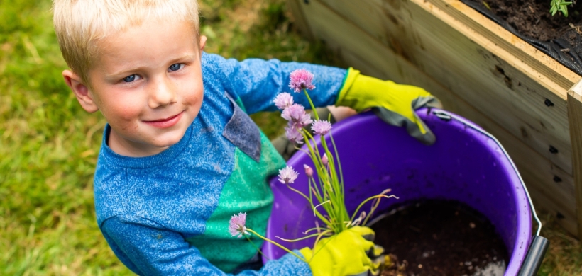 child planting flowers