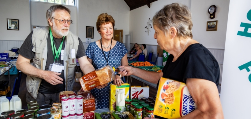 Volunteers serving a customer at Holsworthy Food Hub.