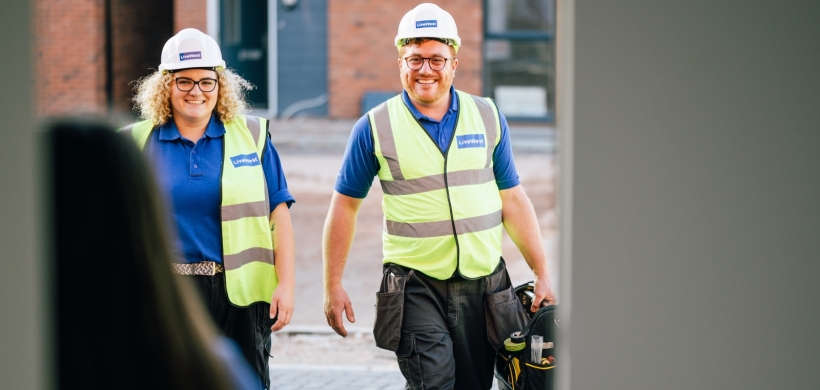 Jamie Sperring and a colleague walking towards a customer's home.