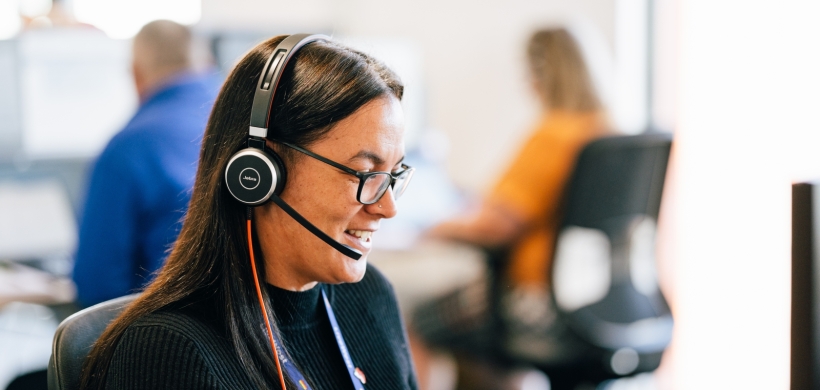 LiveWest colleague speaking on the phone using a headset. 