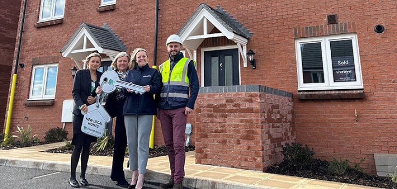 A group of people outside the new homes in Cullompton.