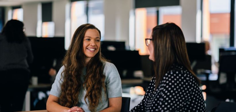 Colleagues talking and smiling