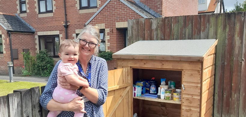 A colleague and baby stood in front of the new pantry. Image: LiveWest