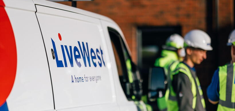 Image of a LiveWest van with colleagues wearing protective equipment next to it.