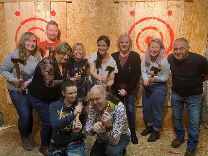 Paul and his friends at an axe throwing class
