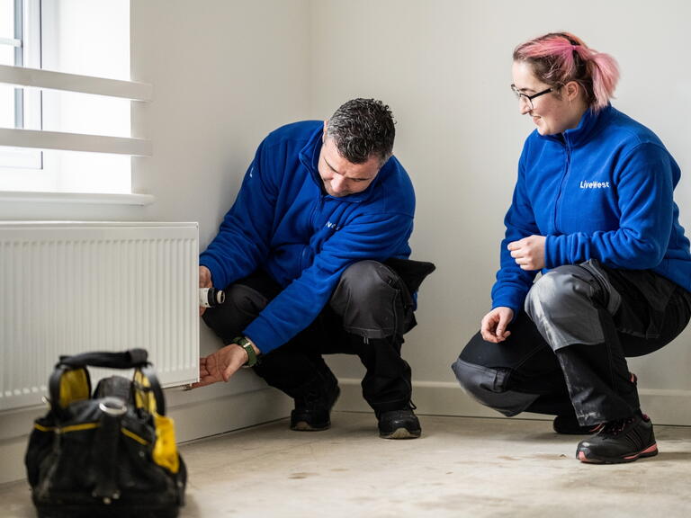 LiveWest colleagues carrying out a repair on a radiator. 
