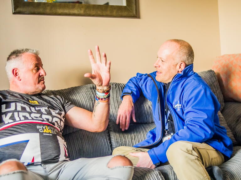 LiveWest colleague speaking to a customer in their home. 