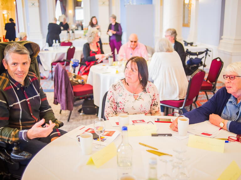 LiveWest customers in a discussion during a customer engagement event. 