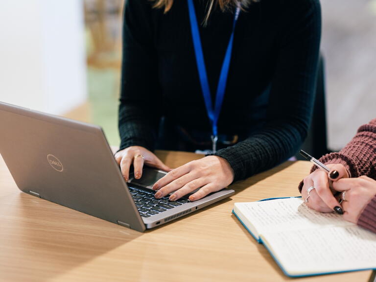 A LiveWest colleague using a laptop. 