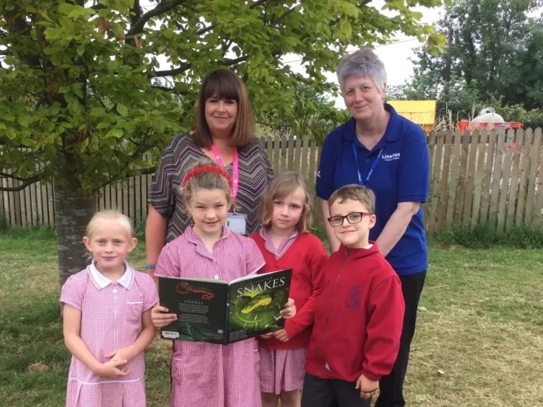 Our colleague Ali Knight presenting the book vouchers to the Headteacher and pupils at Lamerton Primary School.