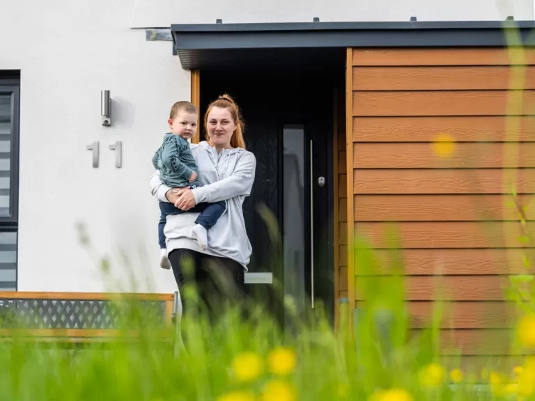 Aga and her son in front of her home in Sparkford