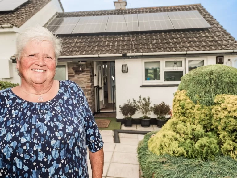 Carol Harris outside her home with new solar panels