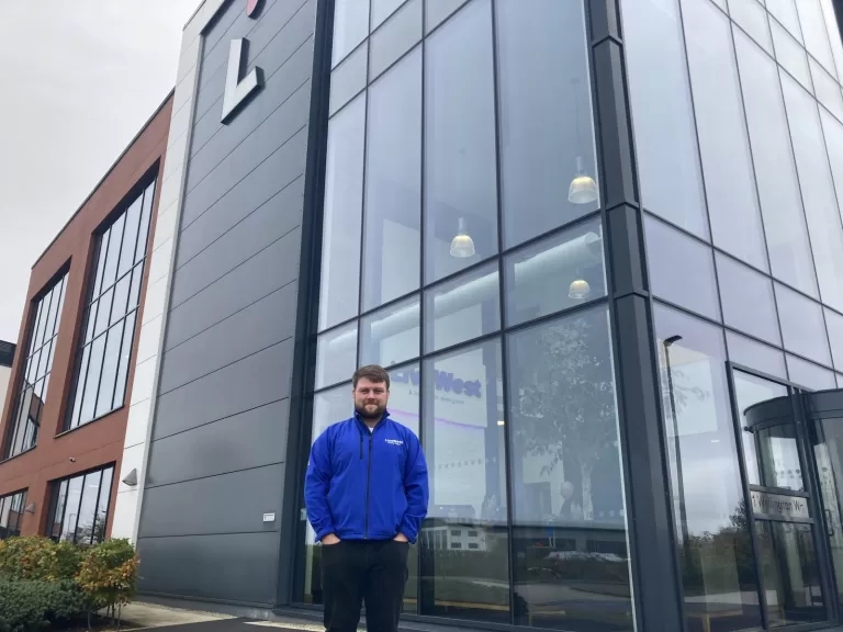 Ben Logan smiling outside of our Exeter office.