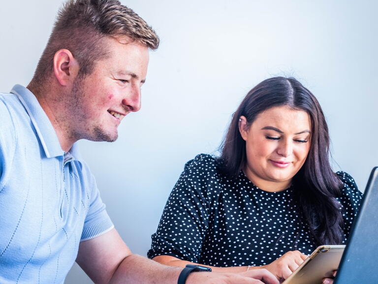 A couple using a laptop. 