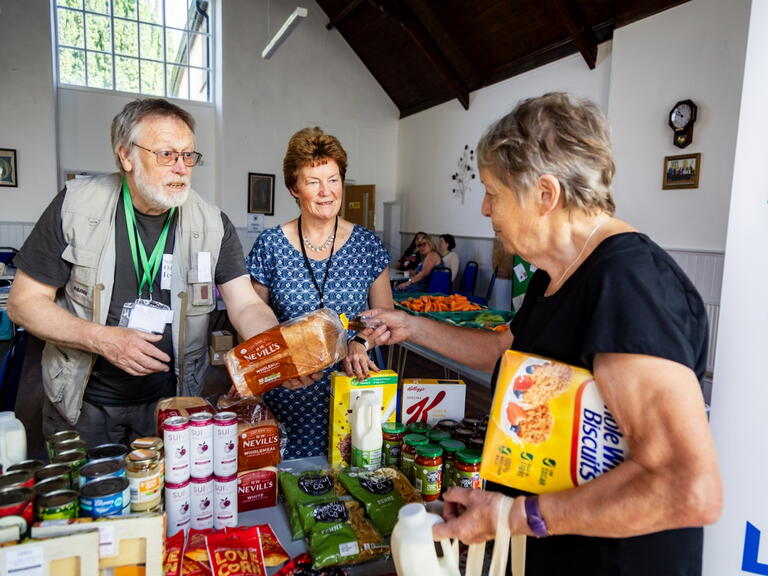 Volunteers serving a customer at Holsworthy Food Hub.