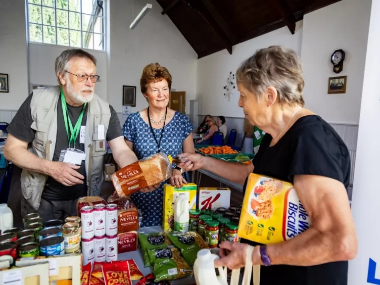 Volunteers serving a customer at Holsworthy Food Hub.
