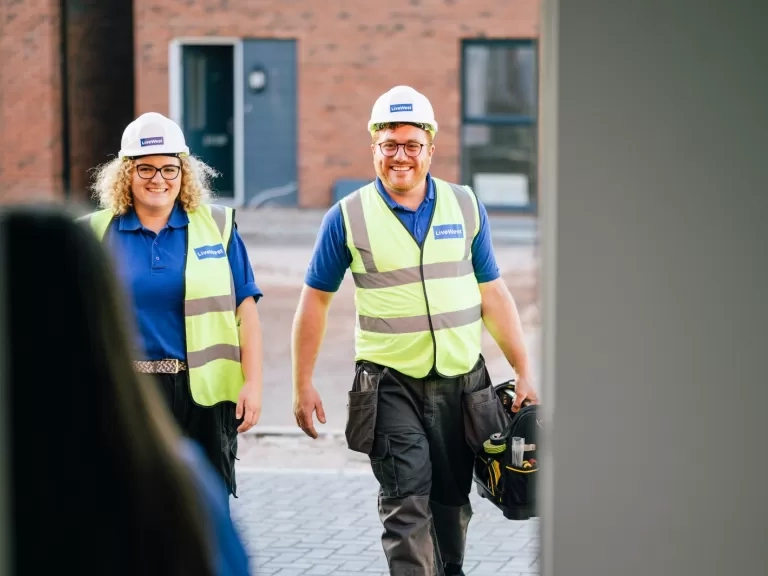 Jamie Sperring and a colleague walking towards a customer's home.