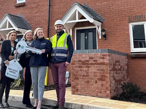 A group of people outside the new homes in Cullompton.