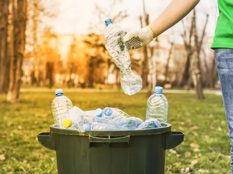 A person recycling plastic bottles. Photo: Shutterstock/HSSstudio