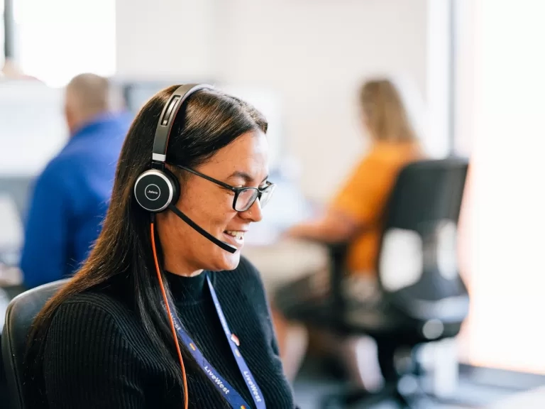 LiveWest colleague speaking on the phone using a headset.