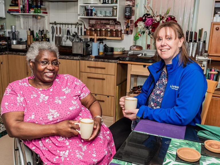 Our InFocus member, Sue smiling alongside one of our colleagues.