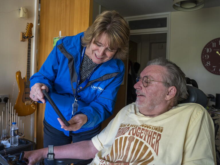 Colleague assisting customer on tablet