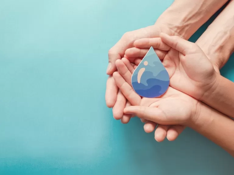hands holding a water drop prop