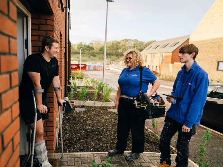 LiveWest colleagues speaking to a customer outside their home. 
