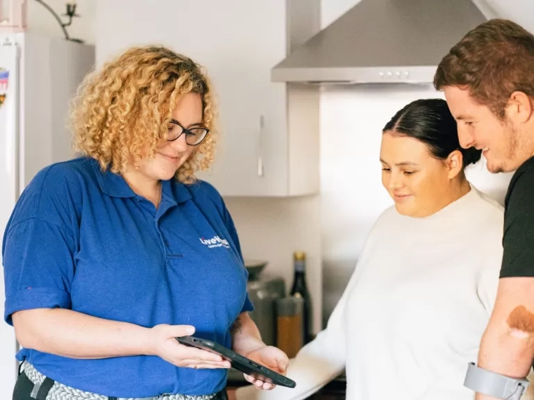 LiveWest colleague talking to two customers in a kitchen