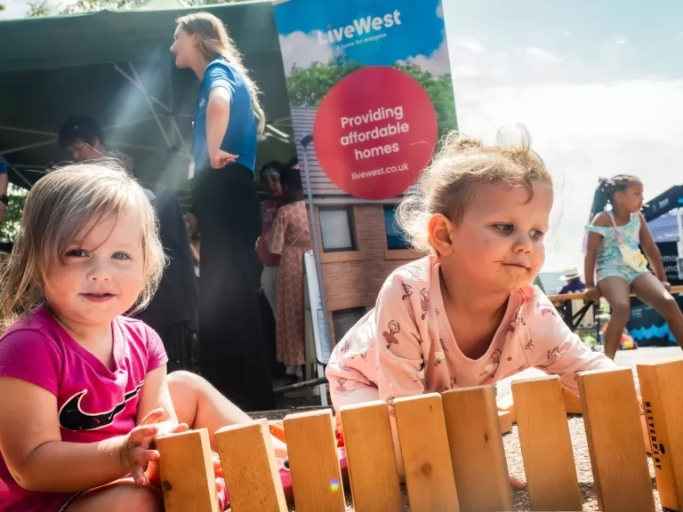 Two girls sat playing with bricks at the fun day.