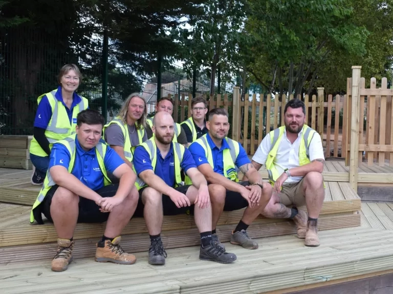 Volunteers sat and stood on the decking they have put in.