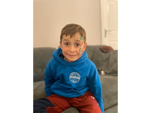 Zachary sat on a sofa who is a winner our competition. 