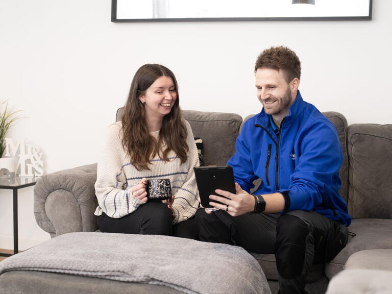 Colleague showing customer new feature on tablet