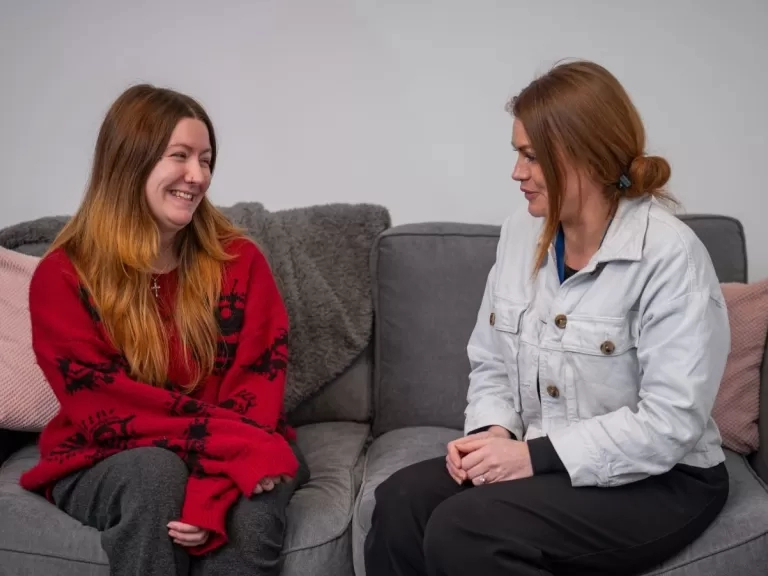 Ash and our colleague on the sofa in her new flat.