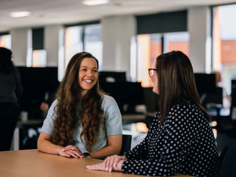 Colleagues talking and smiling