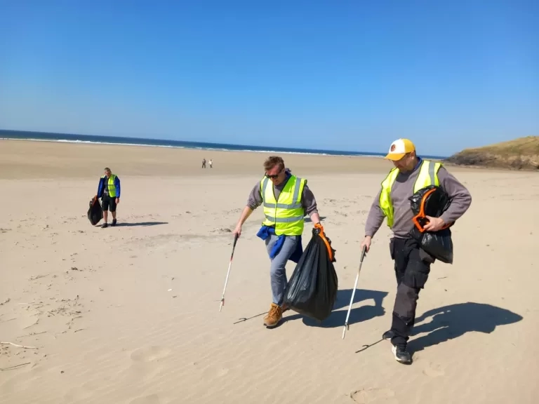 LiveWest colleagues litter picking on a beach.