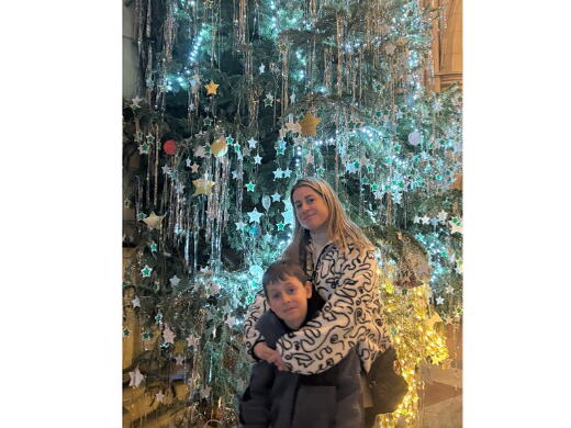 Cara and Zachary in front of the Christmas tree
