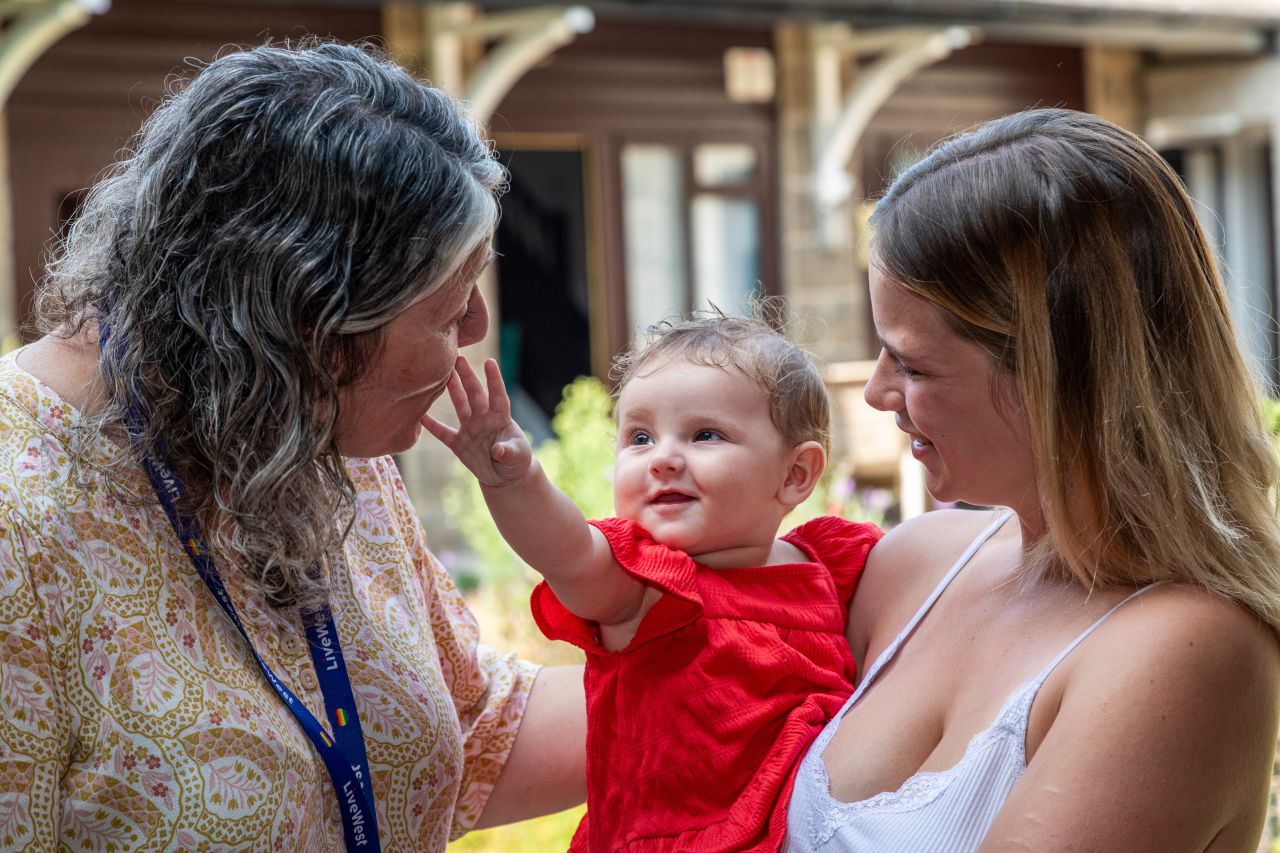 Image of Samara with her child and a LiveWest colleague. 