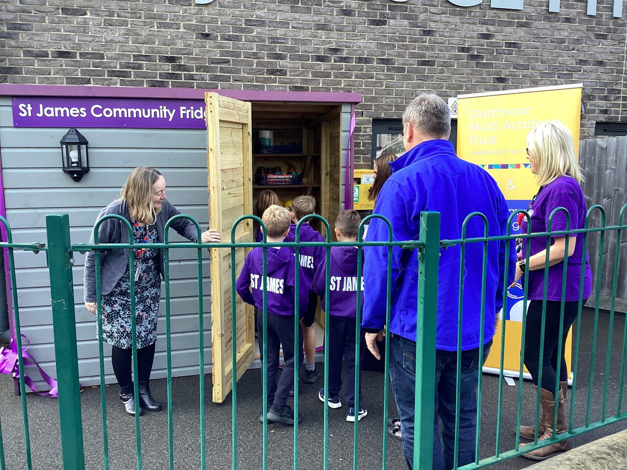 Image of LiveWest colleagues and children entering the community larder