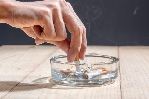 A cigarette being put into an ashtray. 