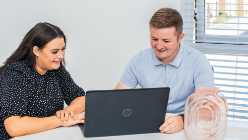 smiling people using a computer